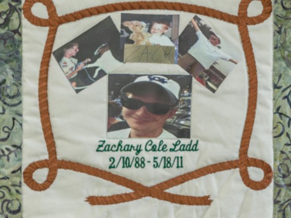 Quilt square for Zachary Ladd with photos of Zachary and a rope draping around the photos.