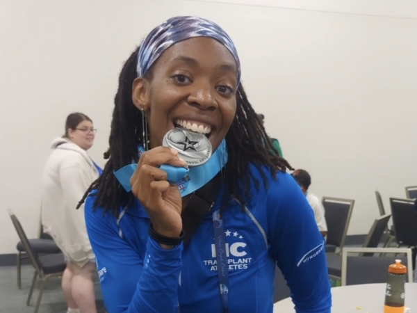 athlete biting medal