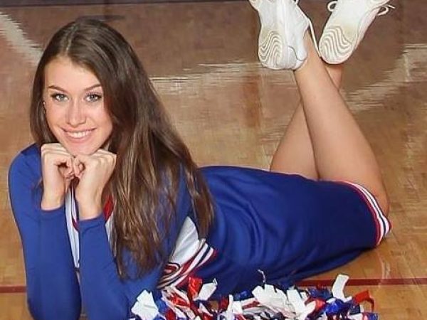 a young woman in a cheer outfit smiling