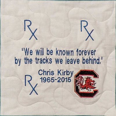 Quilt square for John Kirby with text reading: We will be known forever by the tracks we leave behind.