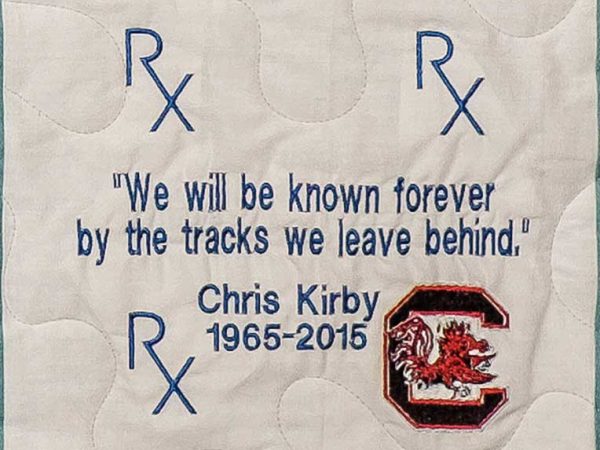 Quilt square for John Kirby with text reading: We will be known forever by the tracks we leave behind.