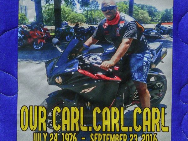 Quilt square for Carl Capps with photo of Carl on a motorcycle and text reading: Our Carl. Carl. Carl.