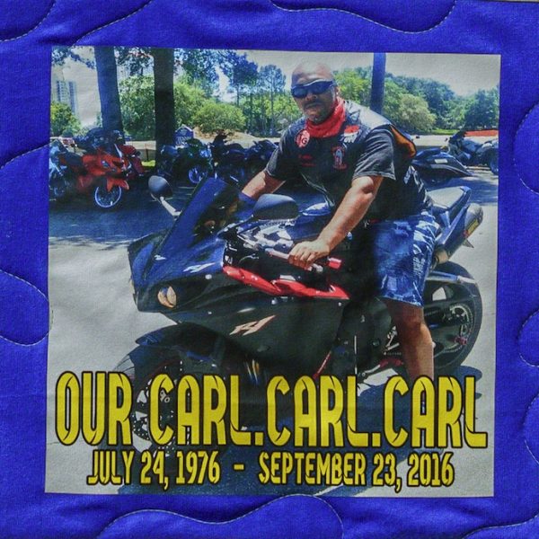 Quilt square for Carl Capps with photo of Carl on a motorcycle and text reading: Our Carl. Carl. Carl.