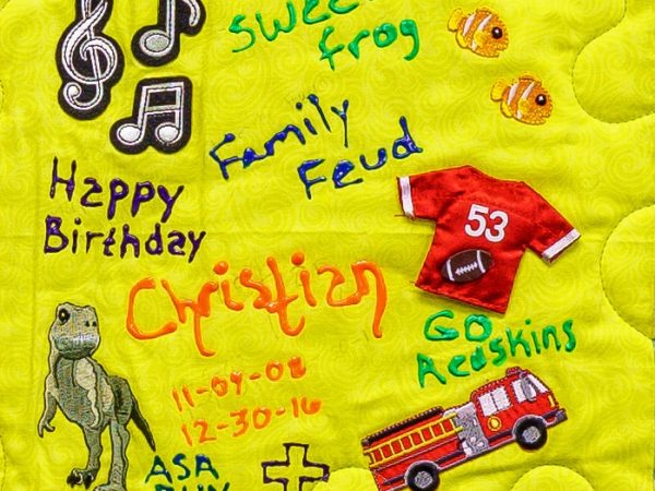 Quilt square for Christian Proctor with patches of music, dinosaurs, a sports jersey, firetruck, and cross. Text reading: sweet frog, family feud, happy birthday, asa run.