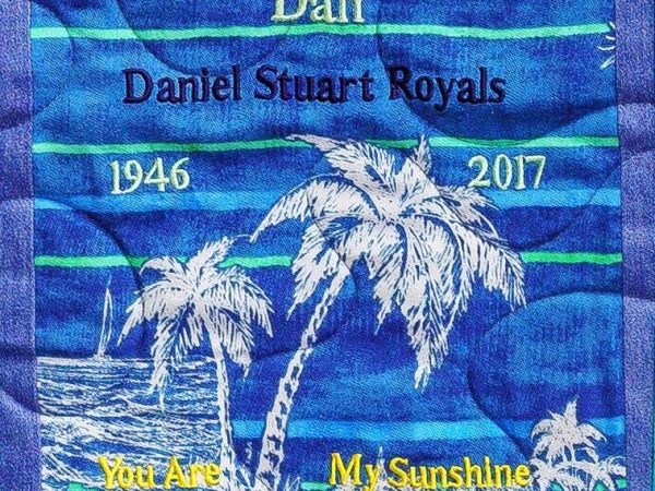 Quilt square for Dan Royals with a beach and palm trees and text reading: You are my sunshine.