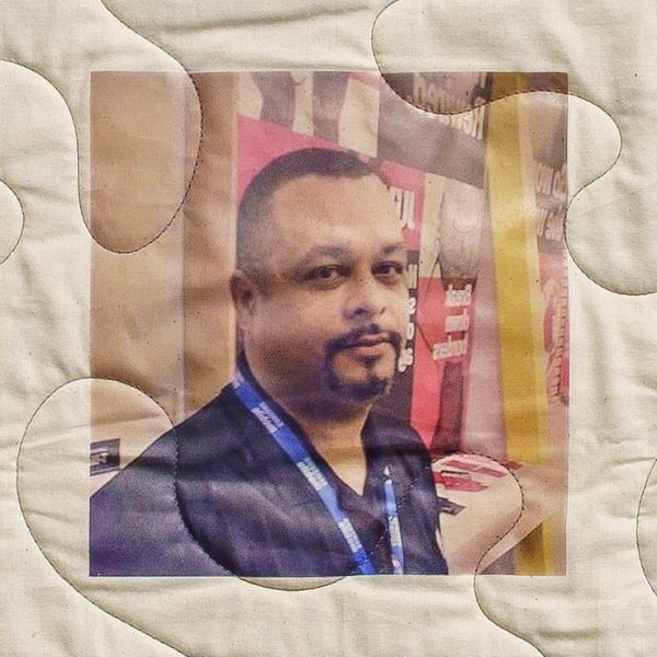 Quilt square for Gary Isom Jr. with a photo of Gary at an event.