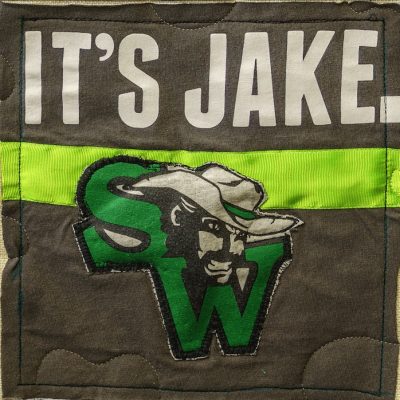 Quilt square for Jake Goeke with a patch of the SW Cowboys Logo and text reading: It’s Jake