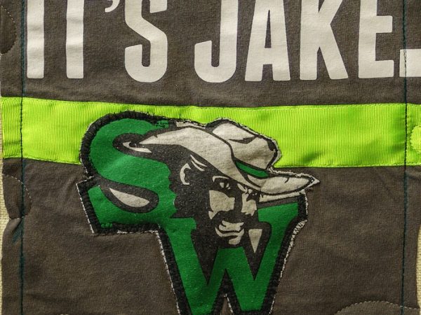 Quilt square for Jake Goeke with a patch of the SW Cowboys Logo and text reading: It’s Jake