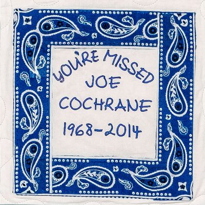 Quilt square for Joe Cochrane with blue pattern and text reading: You’re missed Joe Cochrane.