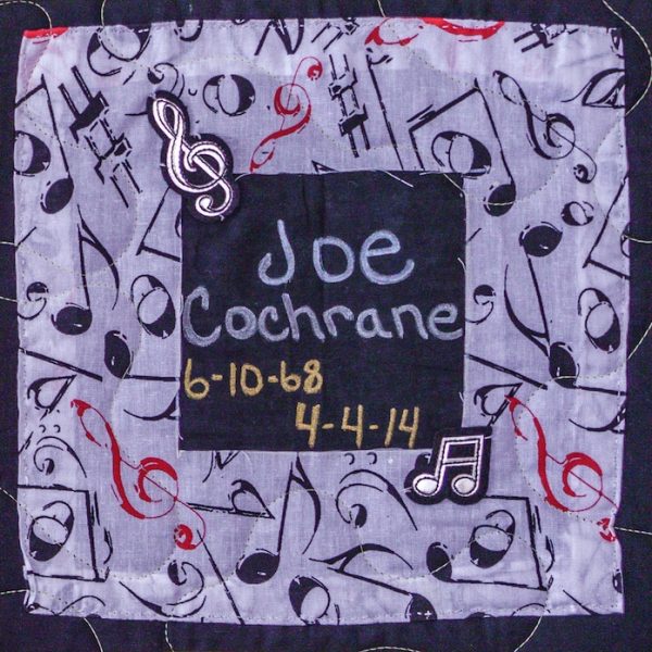 Quilt square for Joe Cochrane with patches of musical notes and symbols