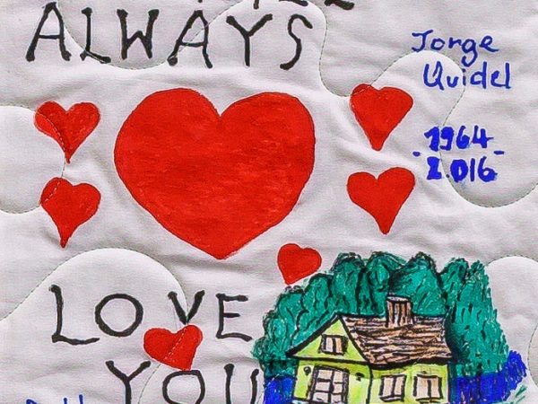 Quilt square for Jorge Quidel with hearts a house, and text reading: We will always love you.