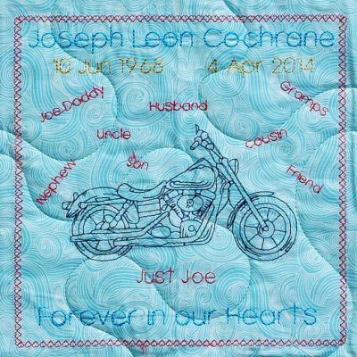 Quilt square for Joseph Cochrane with a motorcycle and text reading Joe Daddy, uncle, husband, son, nephew, friend, cousin, and gramps. Just Joe. Forever in our hearts.