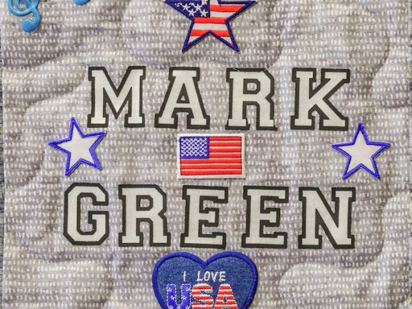 Quilt square for Mark Green Sr. with patches of musical notes, American Flags, and text reading I love USA.