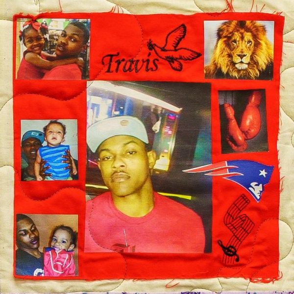 Quilt square for Travis Malloy II with photos of Travis with family and images of boxing gloves, the patriot’s logo, music, a dove, and a lion.