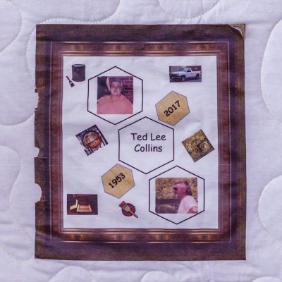 Quilt square for Ted Collins with a wood frame surrounding patches of paint, a globe, a truck, a clock, and of photos of Ted